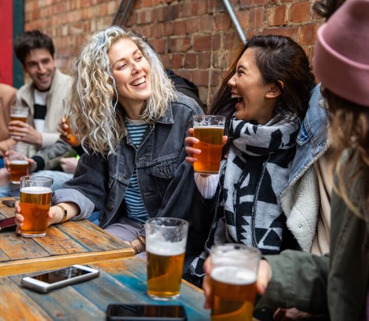 Friends enjoying a drink together while playing Treasure Hunt Birmingham