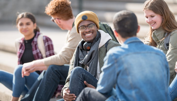 Students sat on steps outside university getting ready to play Treasure Hunt Birmingham